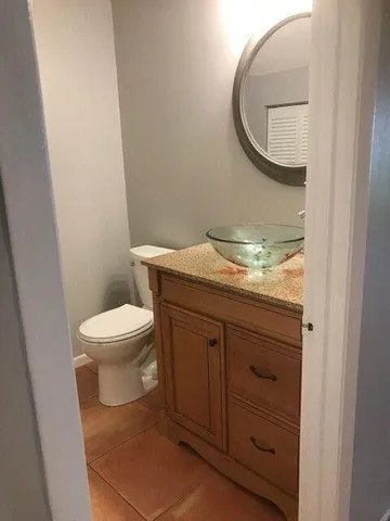 a view of a refrigerator in kitchen and an empty room