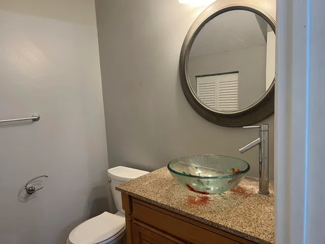 a bathroom with a granite countertop sink and a bathtub