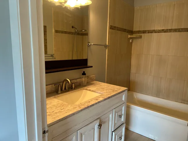 a bathroom with a light fixture and a stove