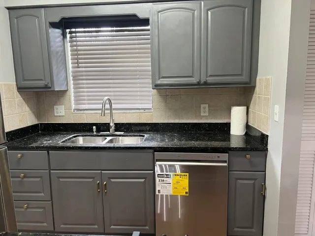 a kitchen with stainless steel appliances granite countertop a sink and cabinets
