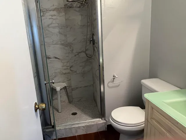 a white toilet sitting next to a bathroom sink