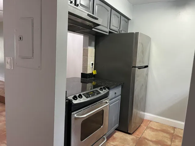 a kitchen with stainless steel appliances a refrigerator and a stove