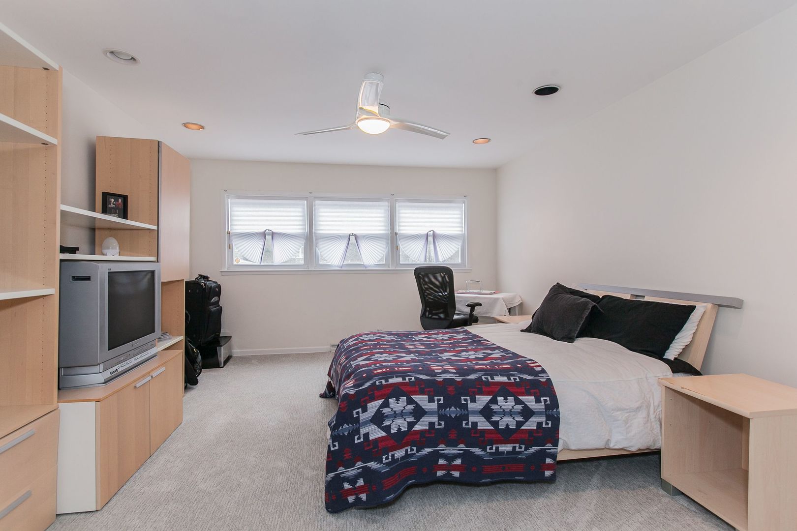 1958 McCraren Road Highland Park, IL 60035 - Photo 20 of 23 a bedroom with a bed and flat tv screen on the dresser
