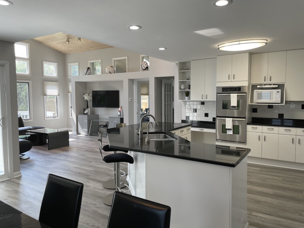 1958 McCraren Road Highland Park, IL 60035 - Photo 9 of 23 a kitchen with stainless steel appliances granite countertop a stove top oven a sink dishwasher a dining table and chairs with wooden floor