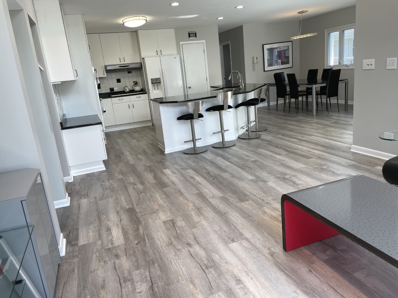 1958 McCraren Road Highland Park, IL 60035 - Photo 10 of 23 a kitchen with stainless steel appliances kitchen island granite countertop a stove a refrigerator and white cabinets with wooden floor