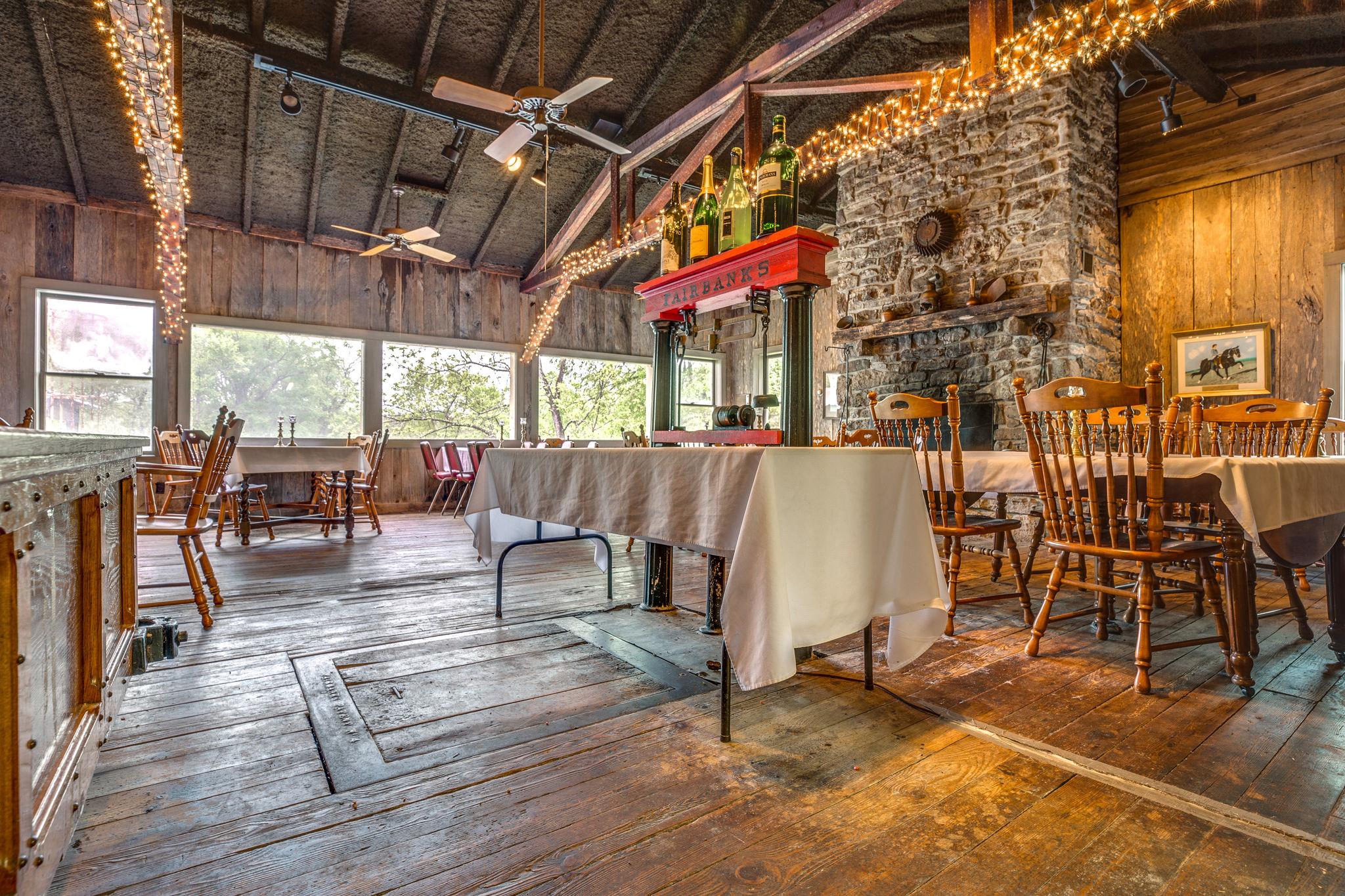 200 Cortner Mill Road Normandy, TN 37360 - Photo 21 of 30 a view of a patio with table and chairs potted plants and floor to ceiling window