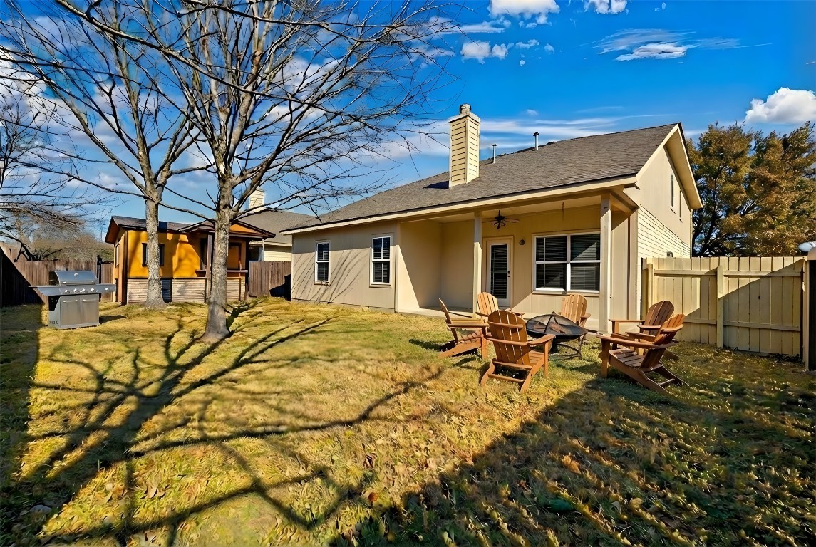 350 Carriage Way Kyle, TX 78640 - Photo 2 of 37 a view of a patio with table and chairs with wooden fence and floor