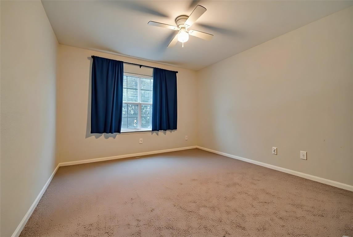 350 Carriage Way Kyle, TX 78640 - Photo 23 of 37 an empty room with windows and fan