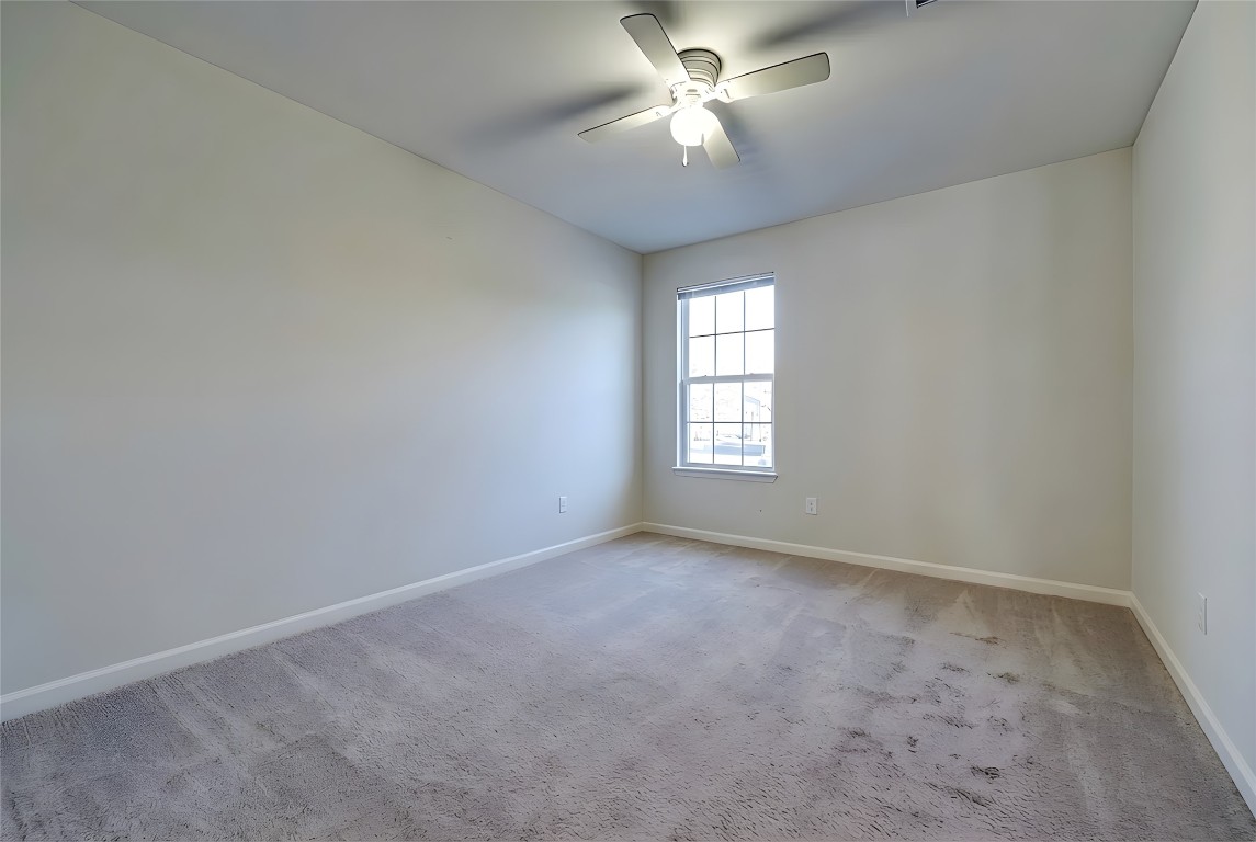 350 Carriage Way Kyle, TX 78640 - Photo 25 of 37 an empty room with a window and a fan
