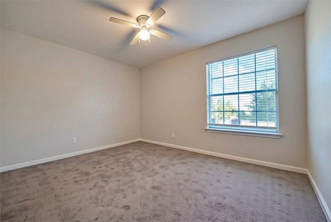 350 Carriage Way Kyle, TX 78640 - Photo 27 of 37 an empty room with a window and a fan