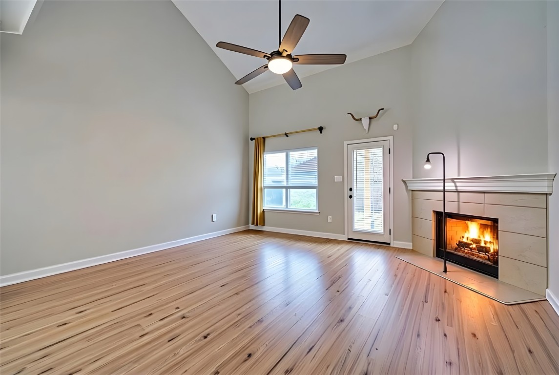 350 Carriage Way Kyle, TX 78640 - Photo 5 of 37 a view of empty room with wooden floor and fireplace