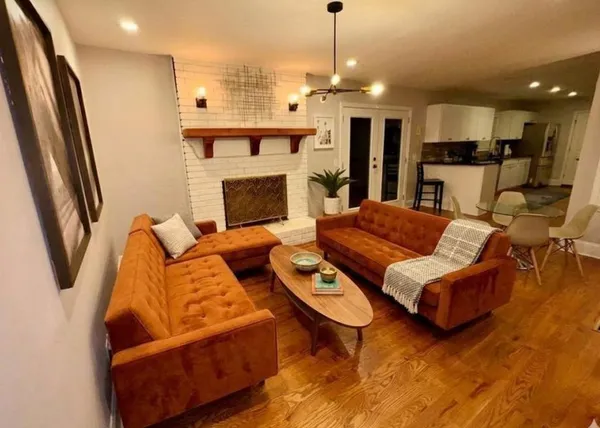 a living room with furniture and a fireplace