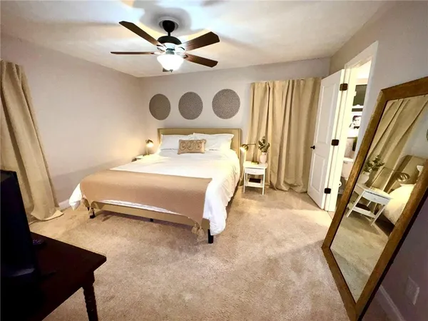a bedroom with a bed and a chandelier