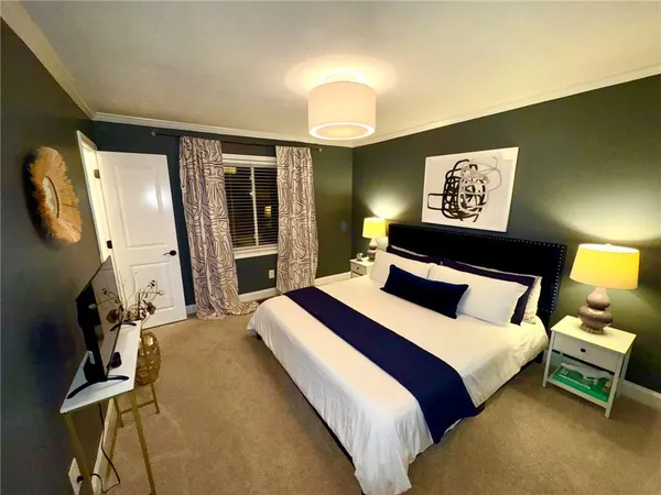 a bedroom with bed and wooden floor