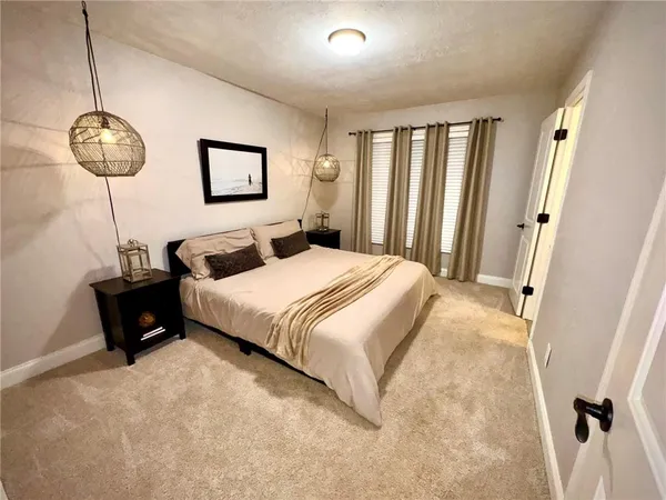 a bedroom with bed and a window