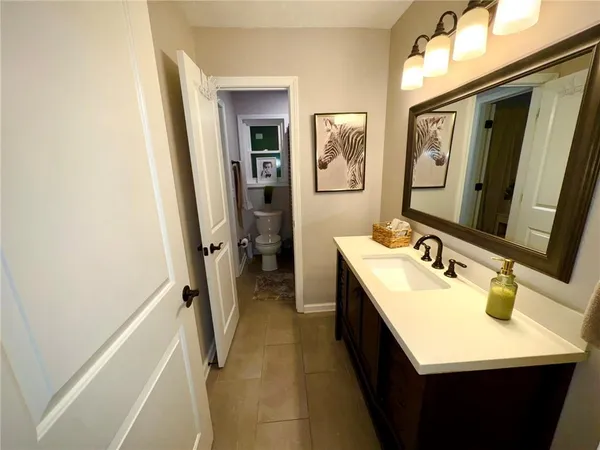 a en suite bathroom with a sink a mirror and a bathtub