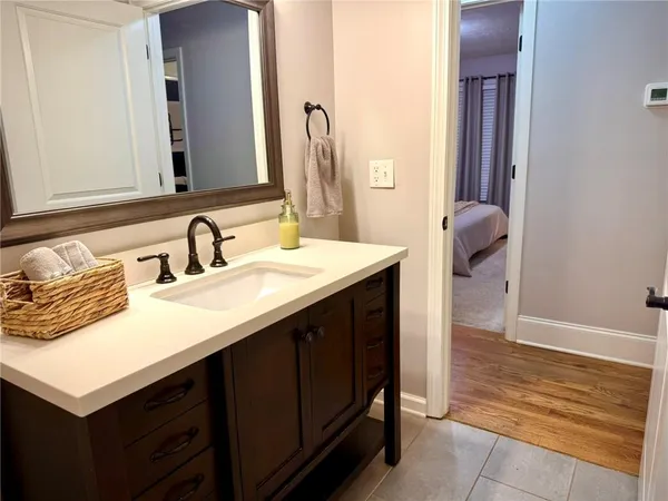 a bathroom with a sink vanity and a mirror