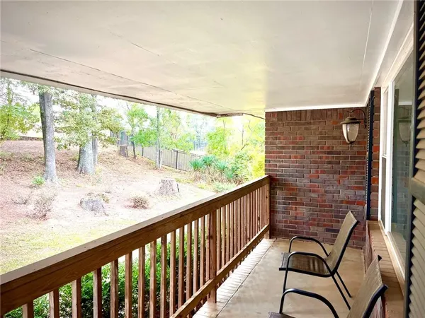 a front view of a house with a garden and parking space
