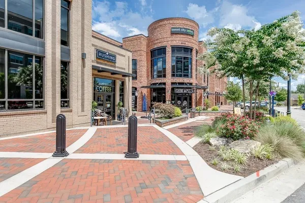 a front view of a house with a garden and pathway