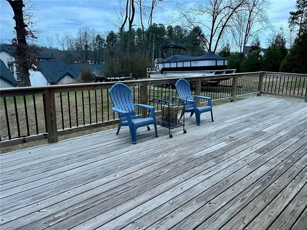 a view of backyard with deck and outdoor seating