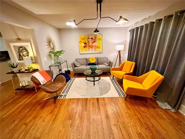 a living room with furniture and a wooden floor