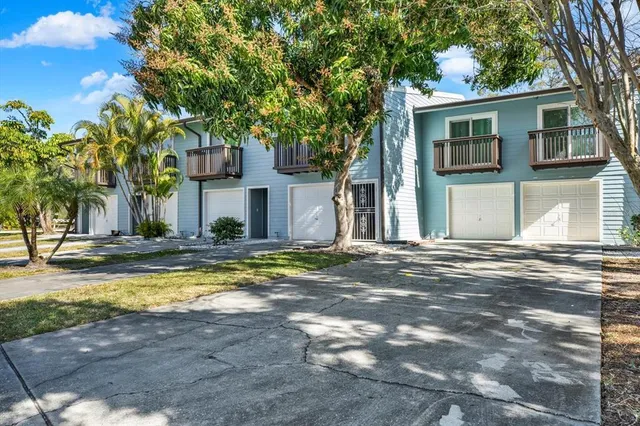 a view of a house with pool and a tree