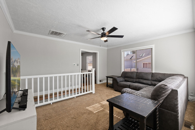 594 850 West Provo, UT 84601 - Photo 3 of 33 Carpeted living area featuring a ceiling fan with integrated lighting, crown molding, and a sliding glass door with blinds