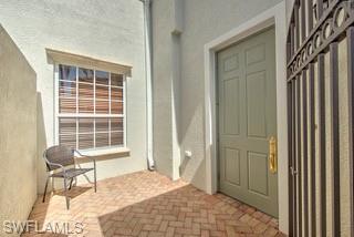 9255 Museo Circle, Unit 204 Naples, FL 34114 - Photo 2 of 27 a view of a bedroom with wooden floor and a chair