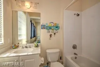 a bathroom with a granite countertop sink a toilet and shower