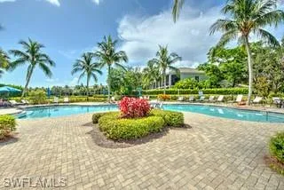 a front view of a house with a yard and palm trees