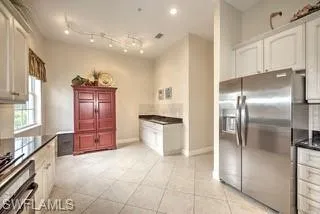 a kitchen with stainless steel appliances granite countertop a refrigerator and a stove