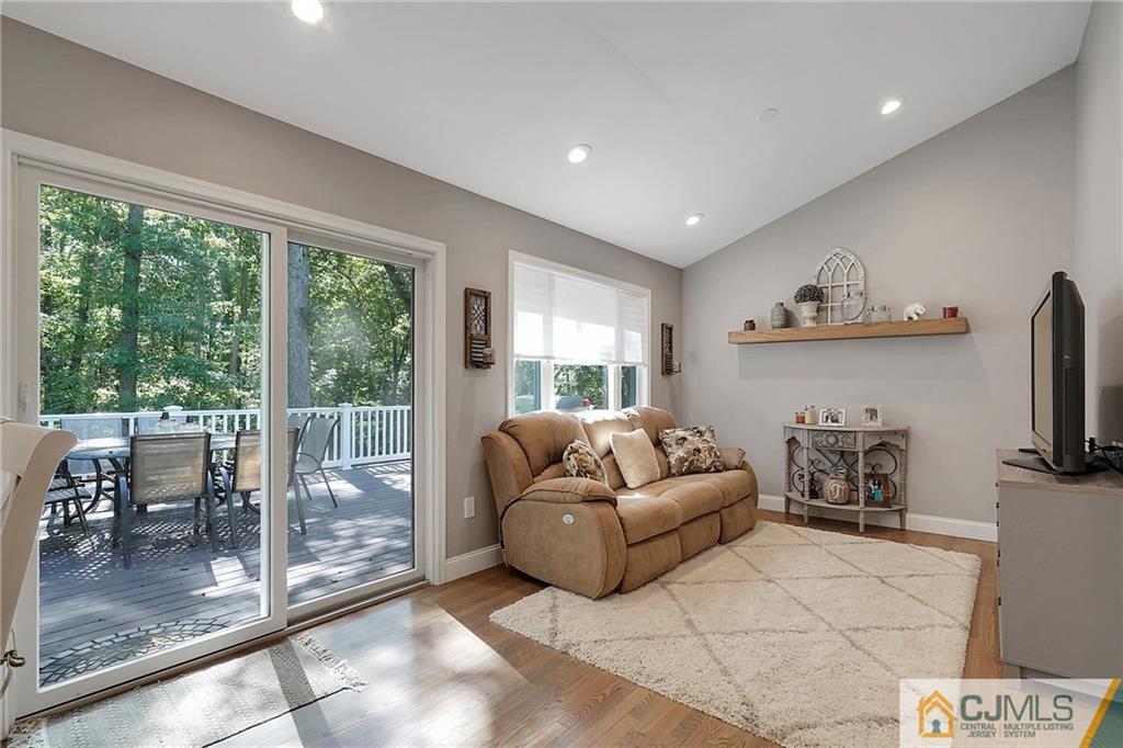 97 Rieder Road Spotswood, NJ 08884 - Photo 19 of 37 a living room with furniture a fireplace and a floor to ceiling window