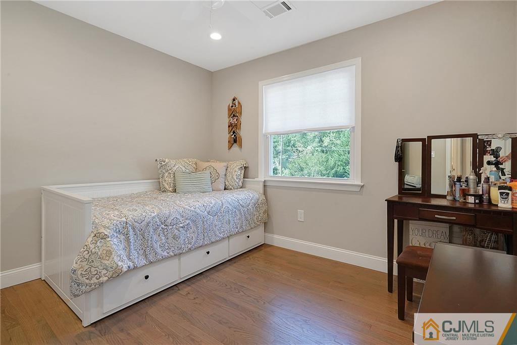 97 Rieder Road Spotswood, NJ 08884 - Photo 22 of 37 a bedroom with a bed and wooden floor