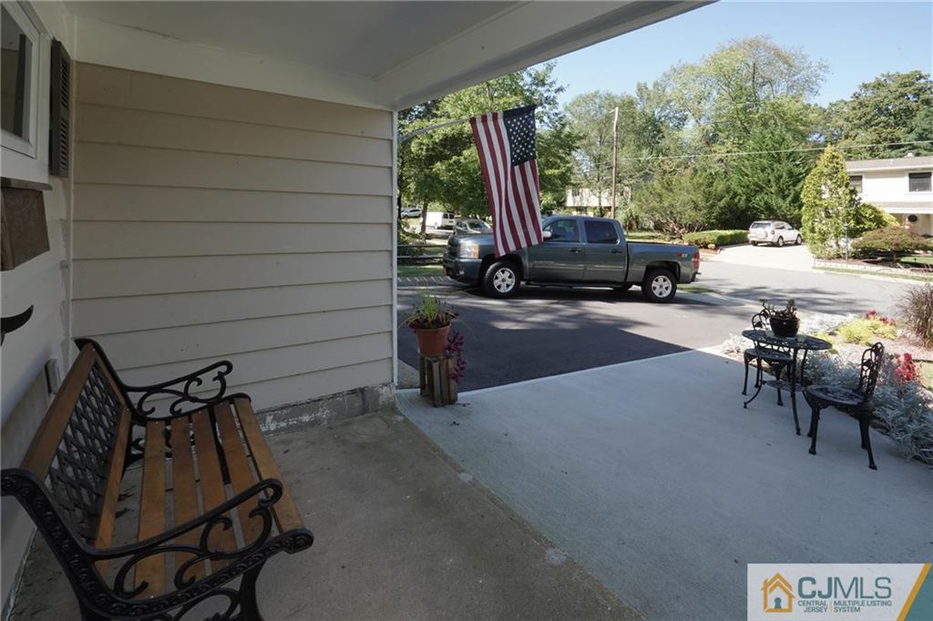 97 Rieder Road Spotswood, NJ 08884 - Photo 6 of 37 a view of a patio with table and chairs with wooden floor and fence