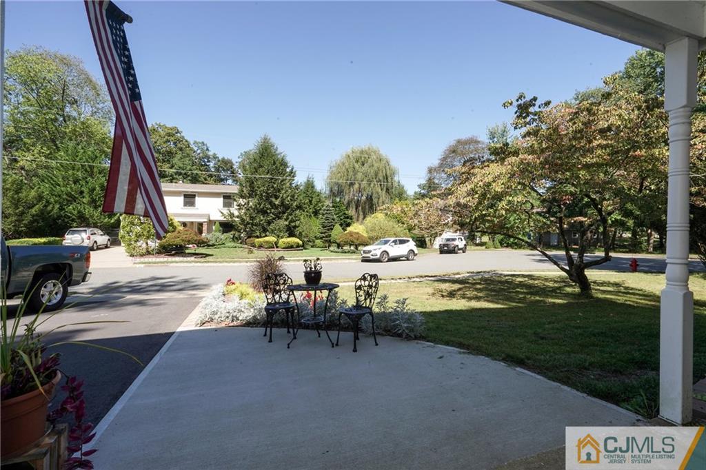 97 Rieder Road Spotswood, NJ 08884 - Photo 7 of 37 a view of a lake with a bench and trees around