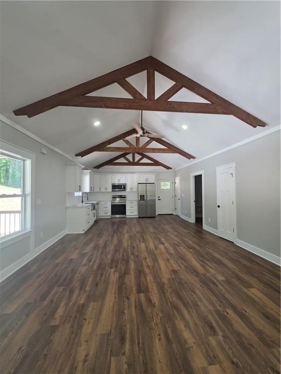 1217 Youngs Farm Road Cedartown, GA 30125 - Photo 11 of 29 an empty room with wooden floor a ceiling fan and windows