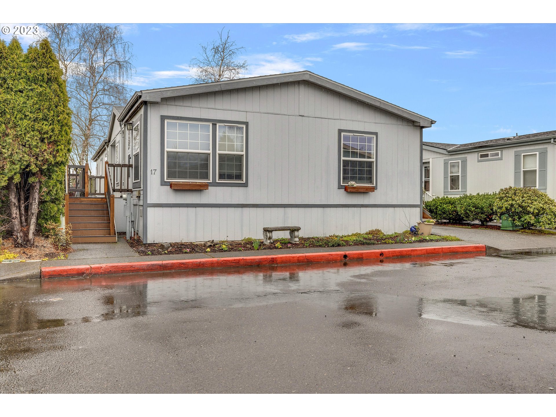 1949 Southeast Palmquist Road, Unit 17 Gresham, OR 97080 - Photo 1 of 31 a front view of a house with a yard