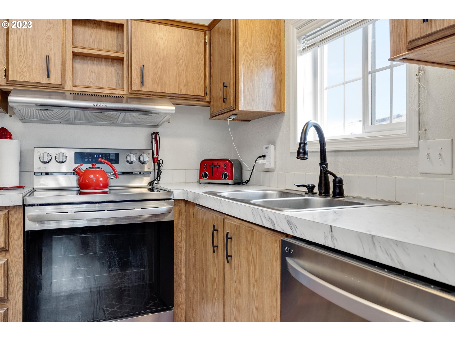 1949 Southeast Palmquist Road, Unit 17 Gresham, OR 97080 - Photo 11 of 31 a kitchen with stainless steel appliances granite countertop a sink stove and cabinets