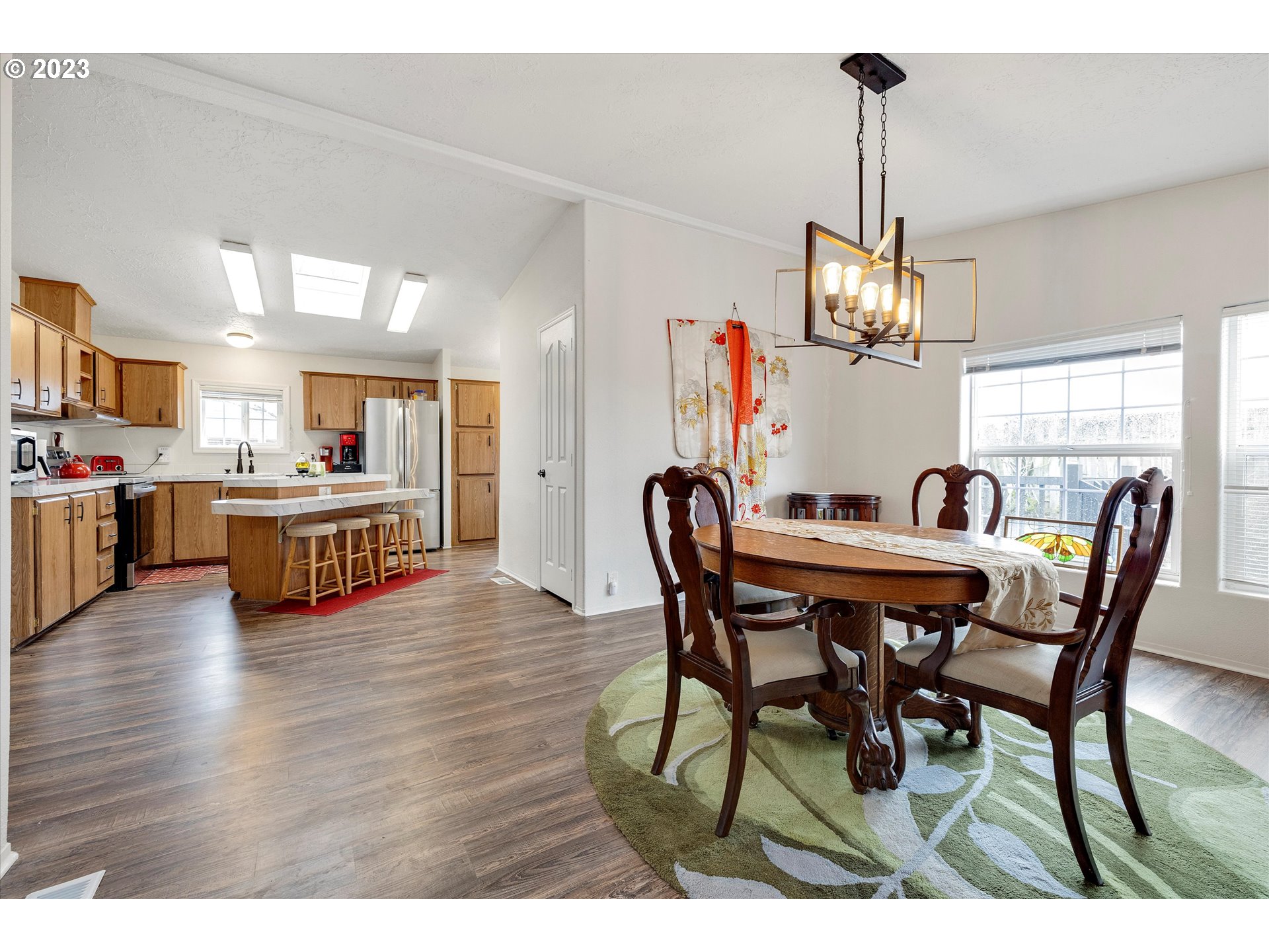 1949 Southeast Palmquist Road, Unit 17 Gresham, OR 97080 - Photo 14 of 31 a view of a dining room with furniture and wooden floor
