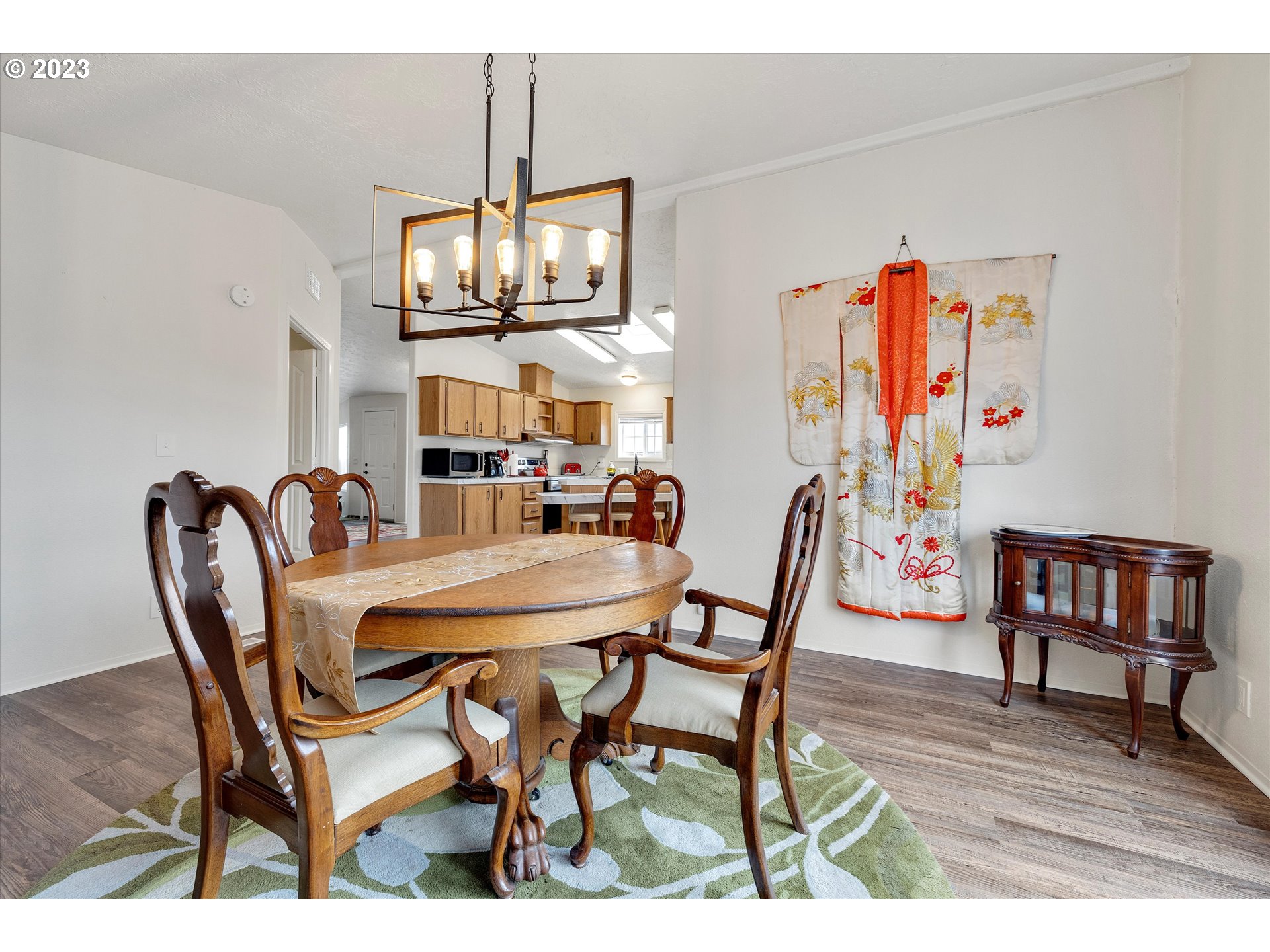 1949 Southeast Palmquist Road, Unit 17 Gresham, OR 97080 - Photo 15 of 31 a view of a dining room with furniture and chandelier
