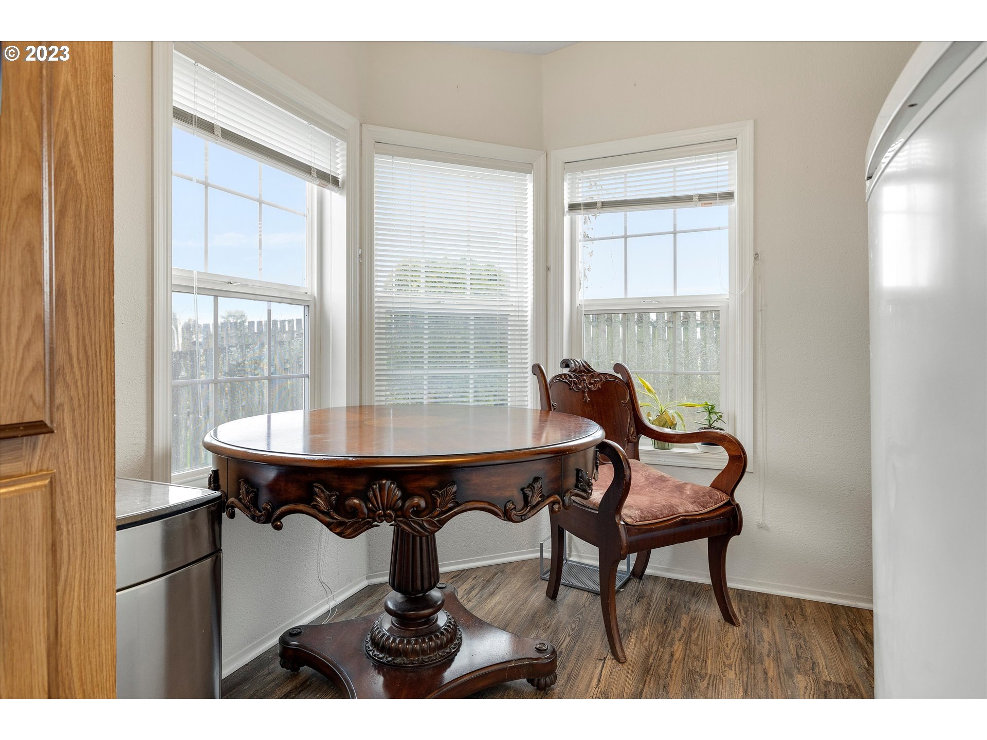 1949 Southeast Palmquist Road, Unit 17 Gresham, OR 97080 - Photo 17 of 31 a dining room with furniture and a floor to ceiling window