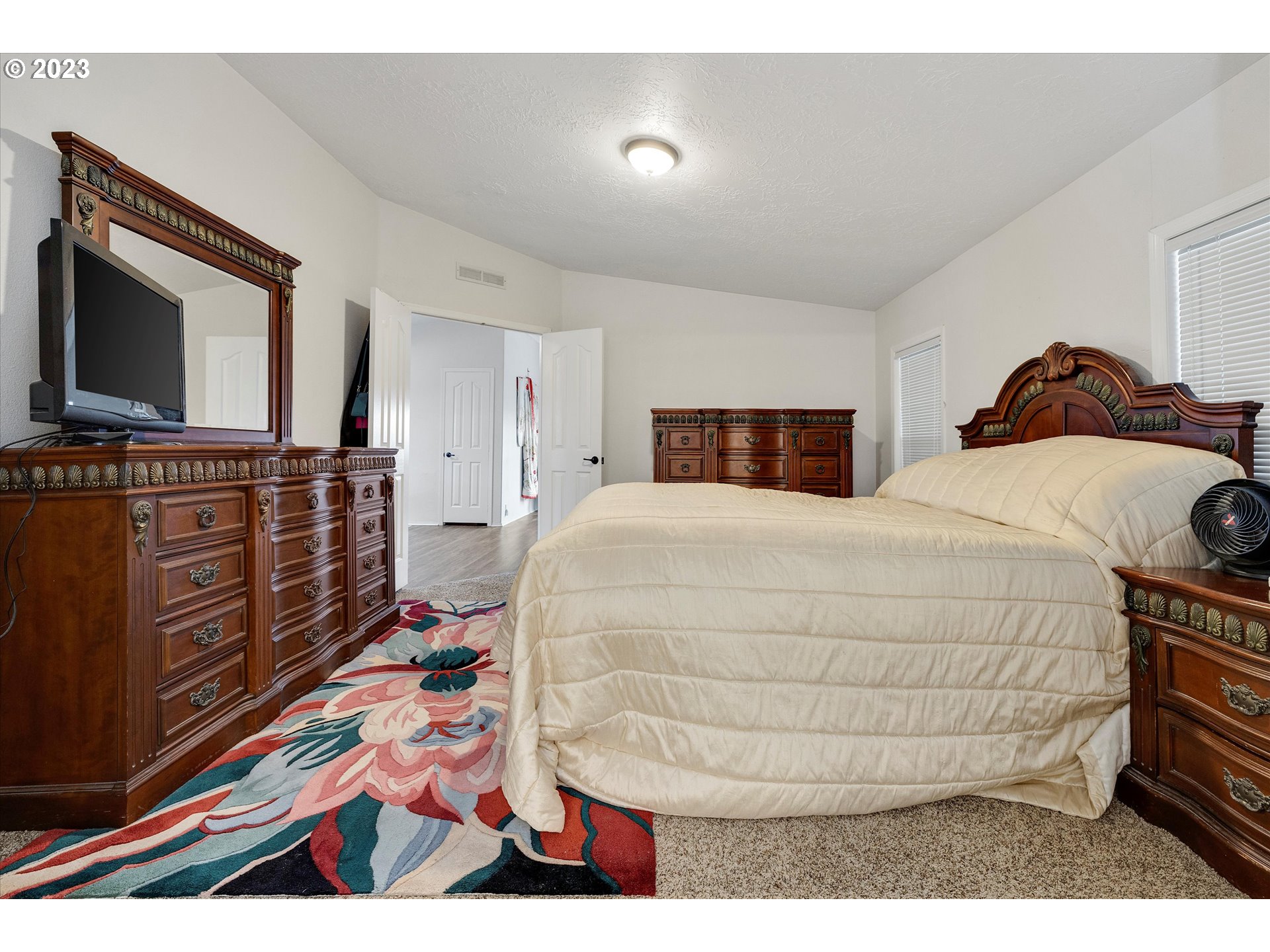 1949 Southeast Palmquist Road, Unit 17 Gresham, OR 97080 - Photo 19 of 31 a bed room with a bed and a television