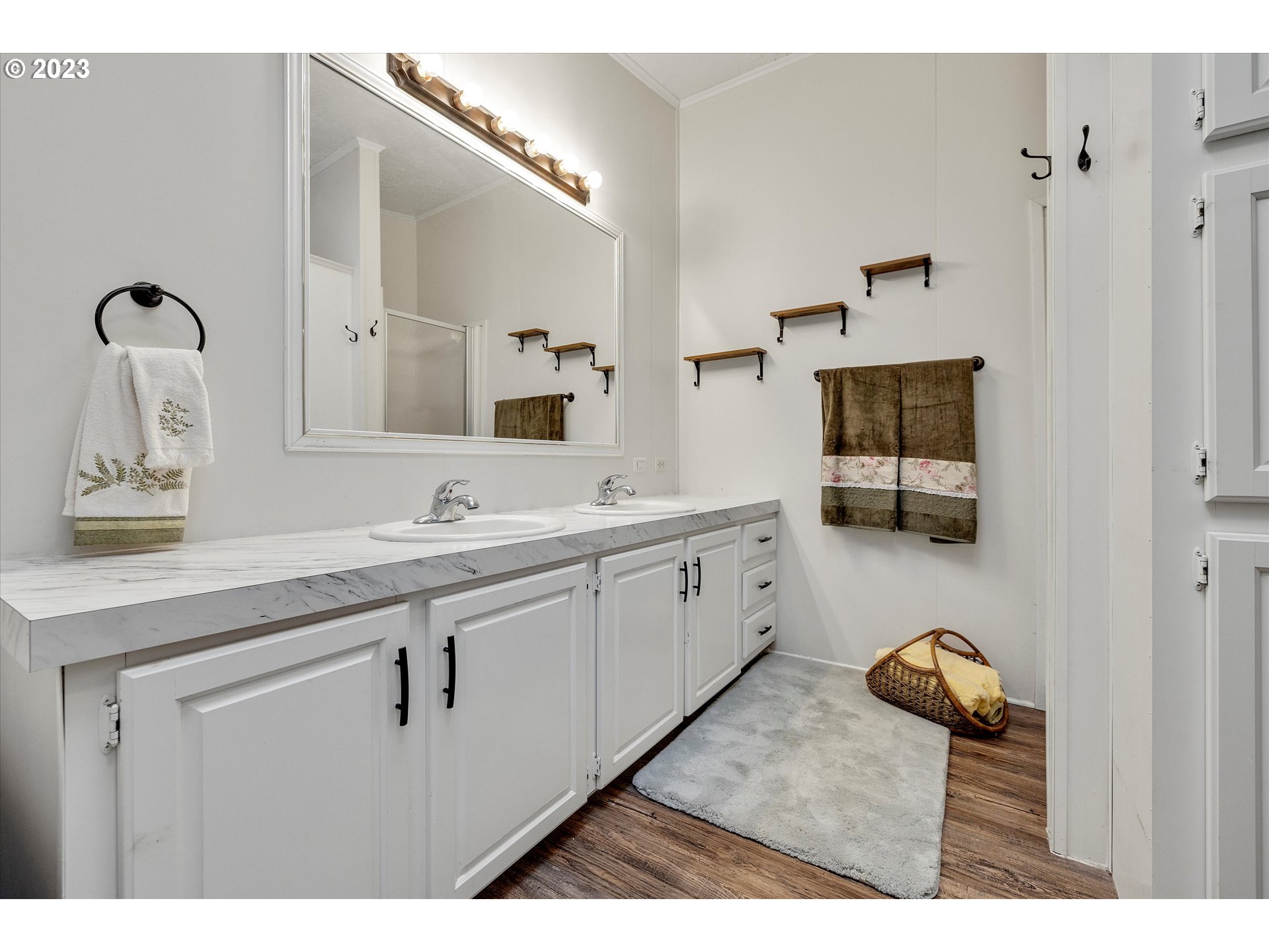 1949 Southeast Palmquist Road, Unit 17 Gresham, OR 97080 - Photo 21 of 31 a spacious bathroom with a sink a mirror and shower