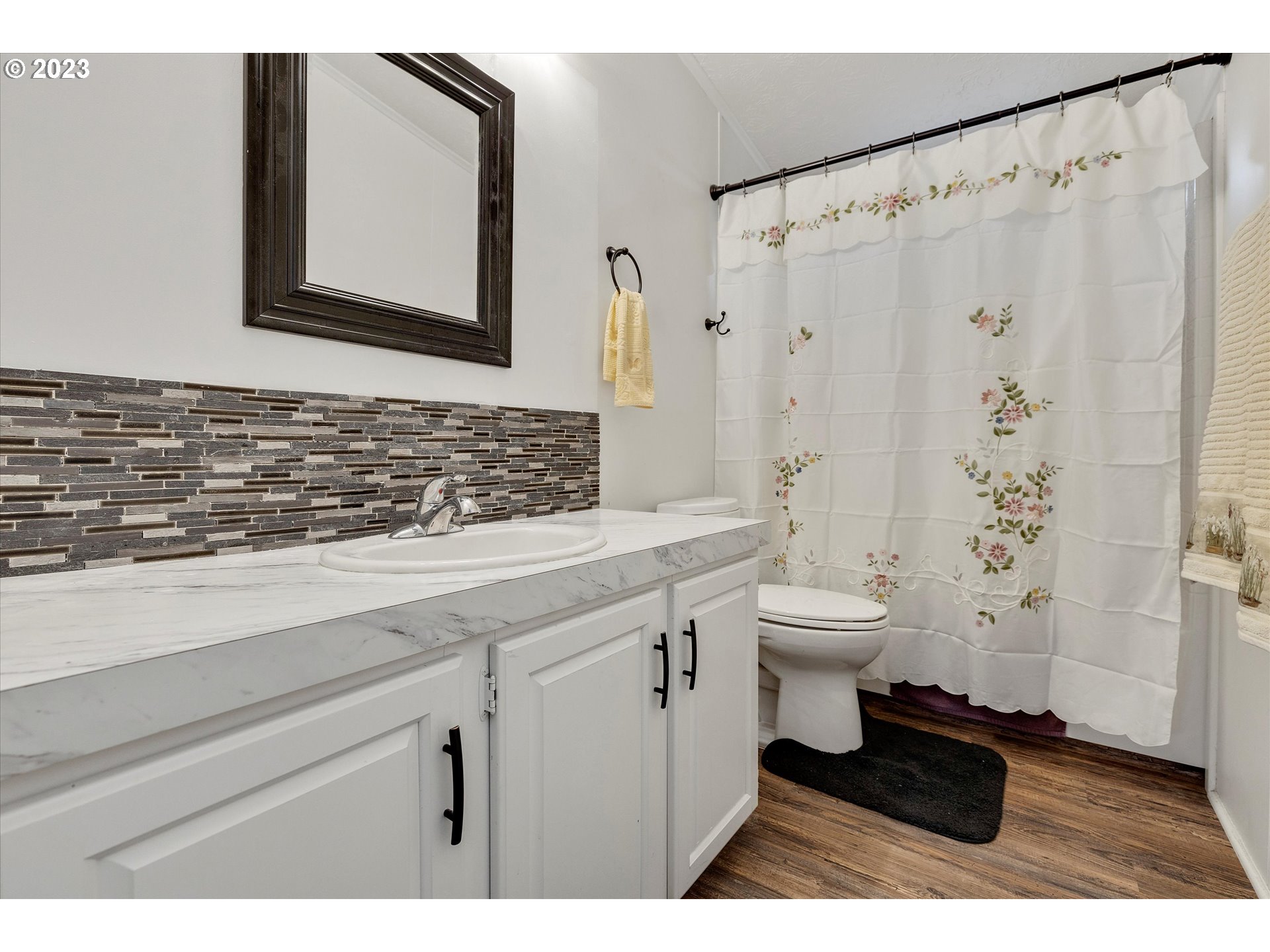 1949 Southeast Palmquist Road, Unit 17 Gresham, OR 97080 - Photo 23 of 31 a bathroom with a toilet a sink and a mirror