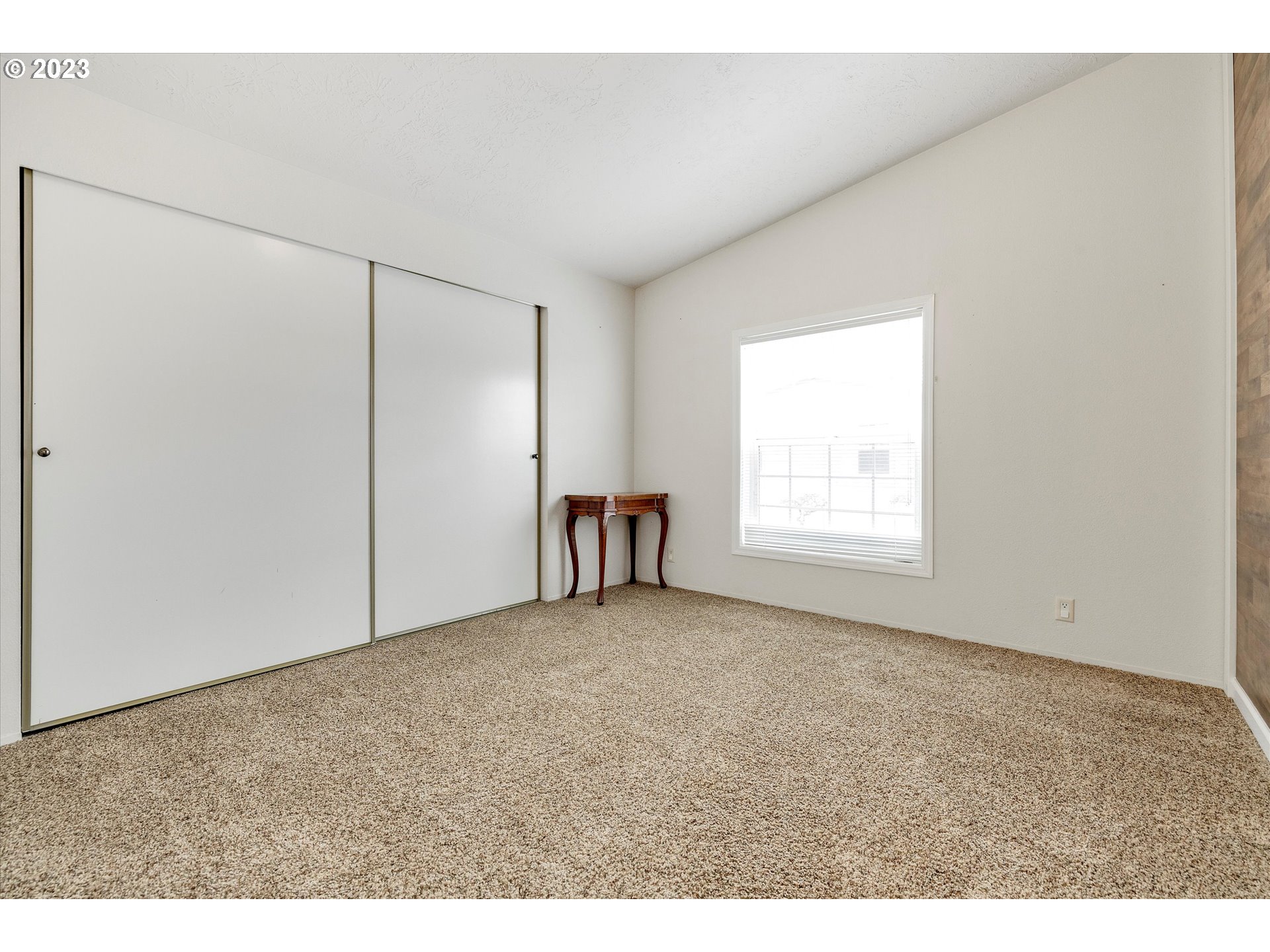 1949 Southeast Palmquist Road, Unit 17 Gresham, OR 97080 - Photo 25 of 31 a view of an empty room with a window