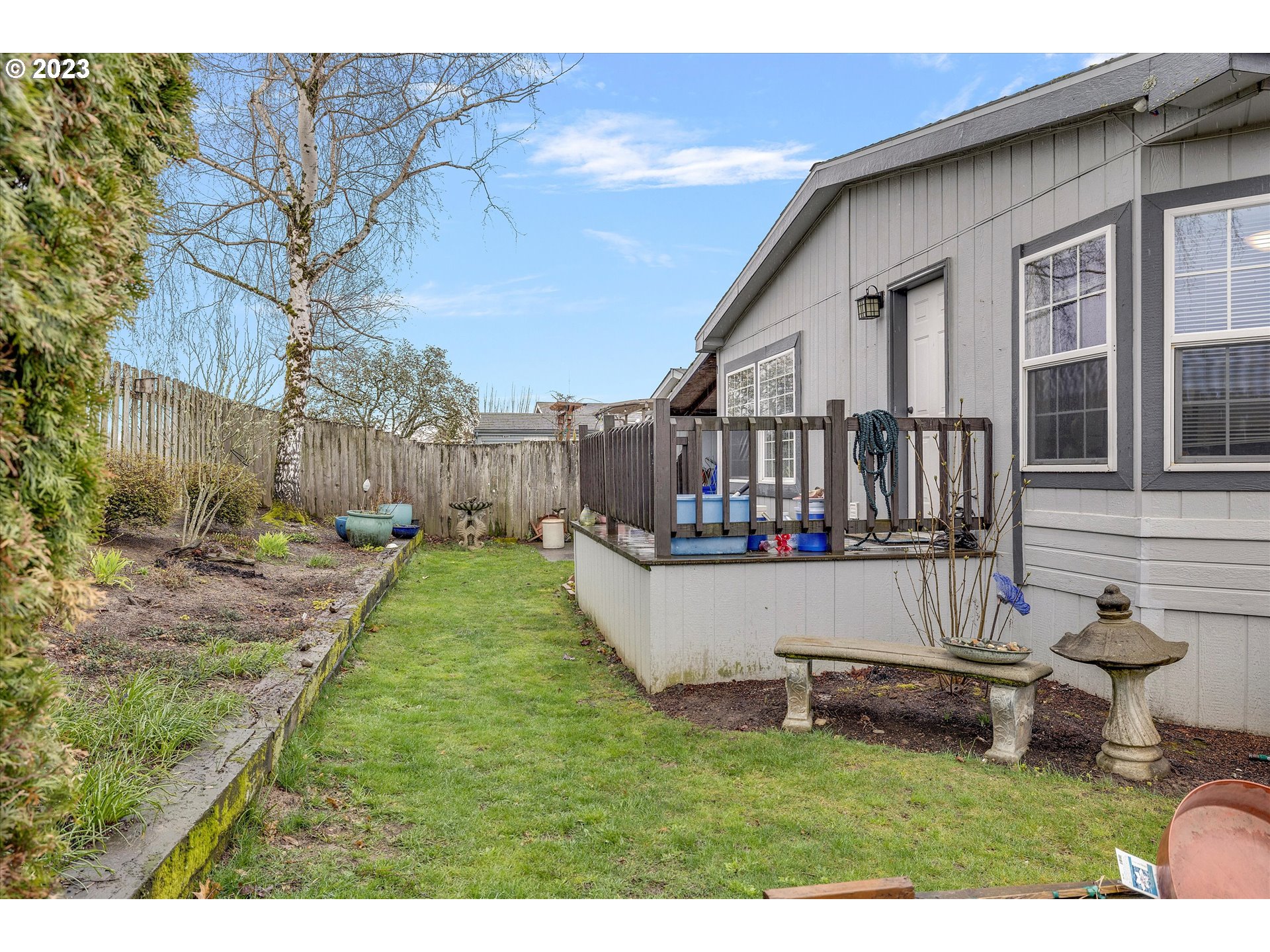 1949 Southeast Palmquist Road, Unit 17 Gresham, OR 97080 - Photo 28 of 31 a view of a house with backyard and sitting area