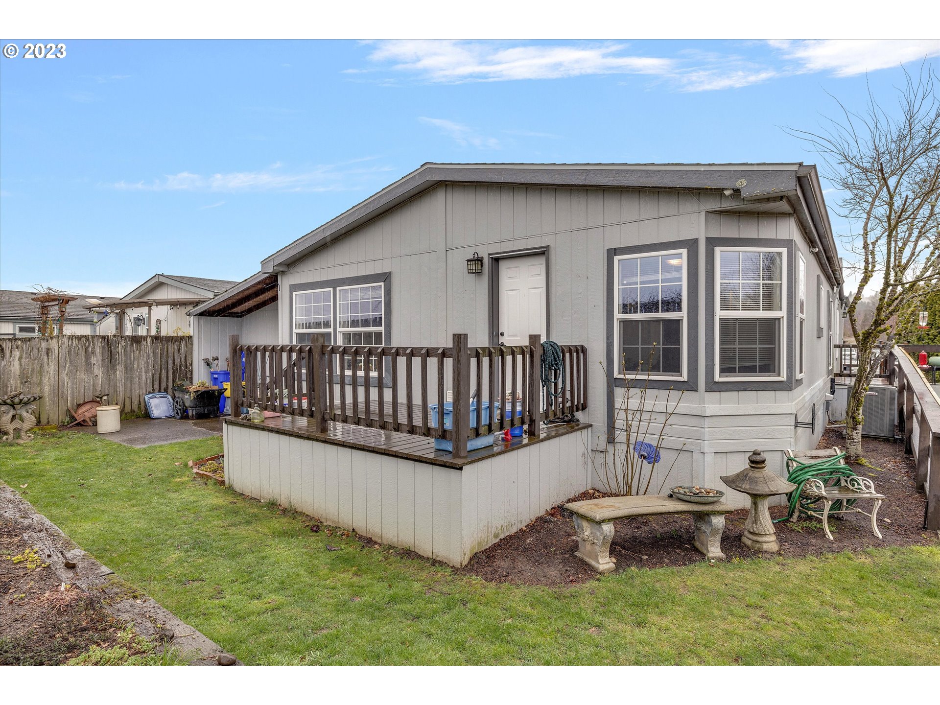 1949 Southeast Palmquist Road, Unit 17 Gresham, OR 97080 - Photo 29 of 31 a view of a house with a yard and deck
