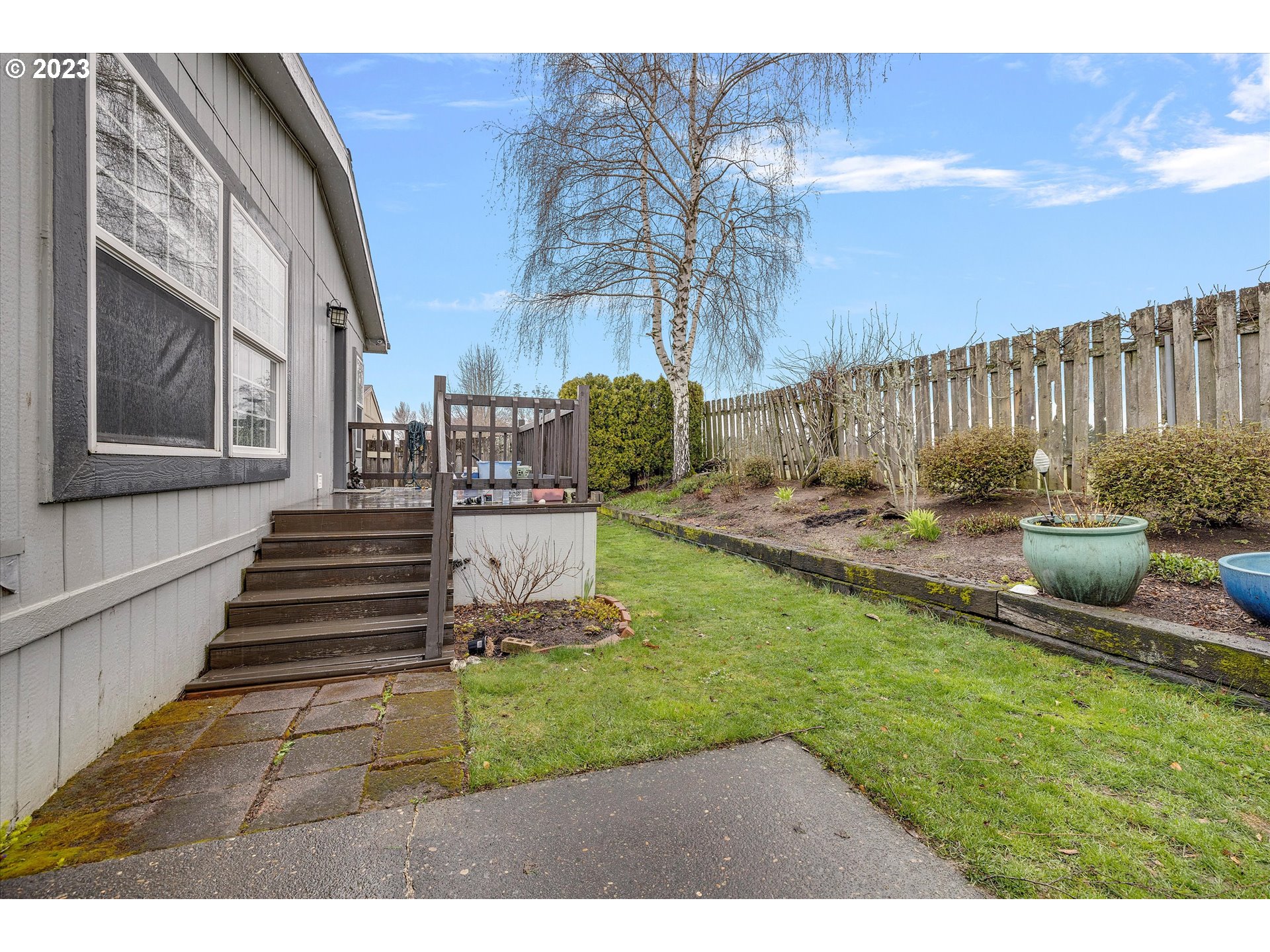 1949 Southeast Palmquist Road, Unit 17 Gresham, OR 97080 - Photo 30 of 31 a view of a backyard with sitting area