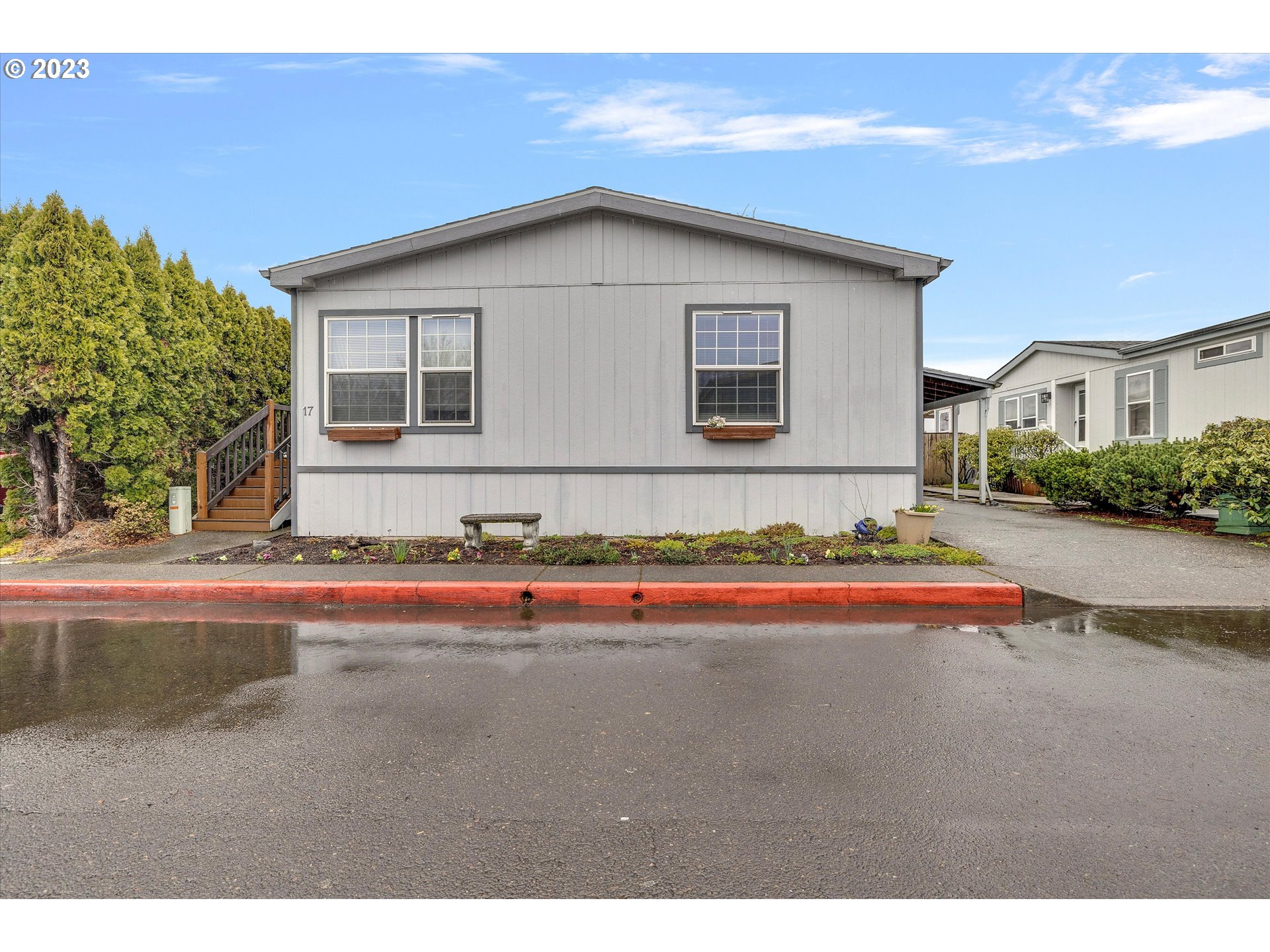 1949 Southeast Palmquist Road, Unit 17 Gresham, OR 97080 - Photo 3 of 31 a front view of a house with a yard