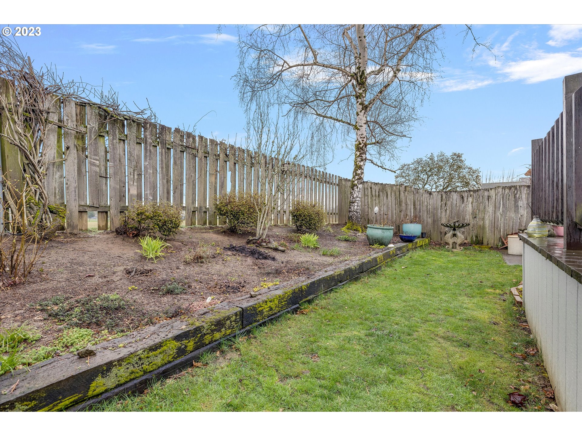 1949 Southeast Palmquist Road, Unit 17 Gresham, OR 97080 - Photo 31 of 31 a backyard of a house with lots of green space